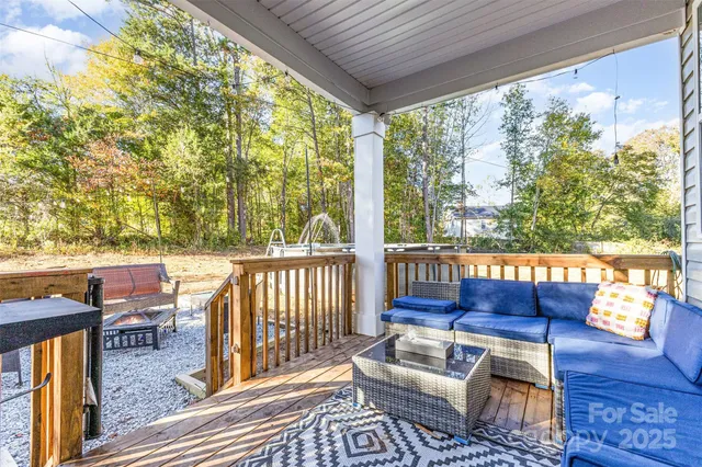 a balcony with wooden floor and outdoor seating