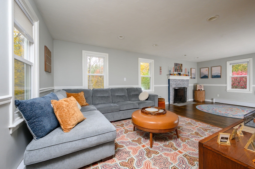67 School Street Hanover, MA 02339 - Photo 11 of 29 a living room with furniture a fireplace and a large window