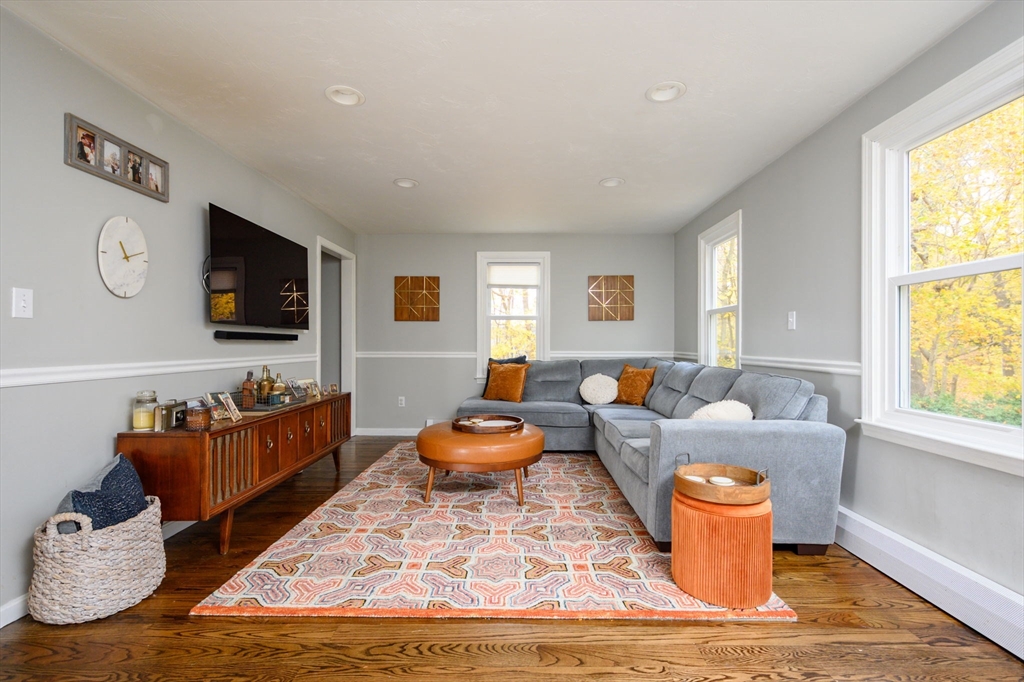 67 School Street Hanover, MA 02339 - Photo 12 of 29 a living room with furniture and a flat screen tv