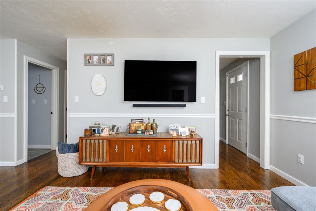 67 School Street Hanover, MA 02339 - Photo 13 of 29 a living room with furniture and a flat screen tv
