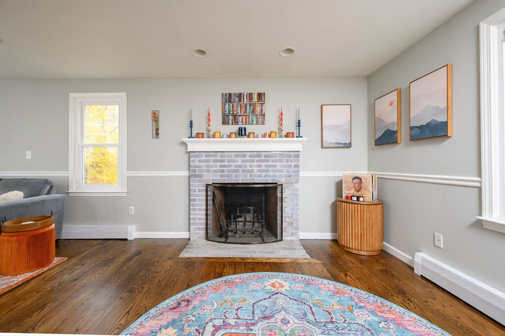 67 School Street Hanover, MA 02339 - Photo 14 of 29 a living room with a fireplace and a window