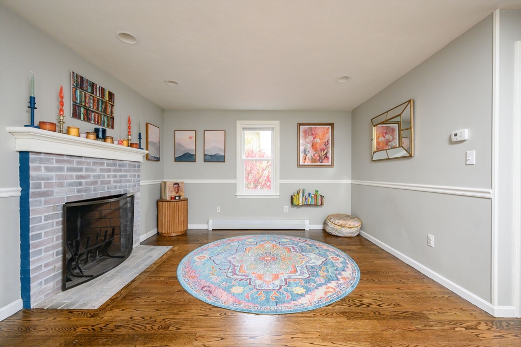 67 School Street Hanover, MA 02339 - Photo 15 of 29 a living room with furniture and a fireplace