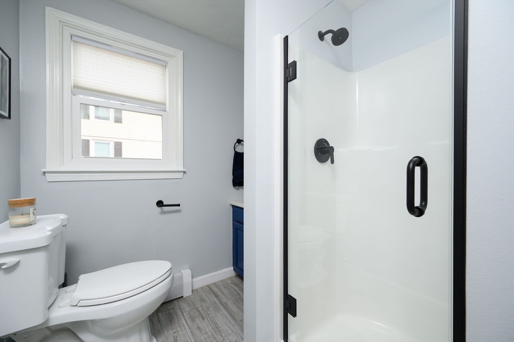 67 School Street Hanover, MA 02339 - Photo 16 of 29 a bathroom with a toilet sink a shower and mirror