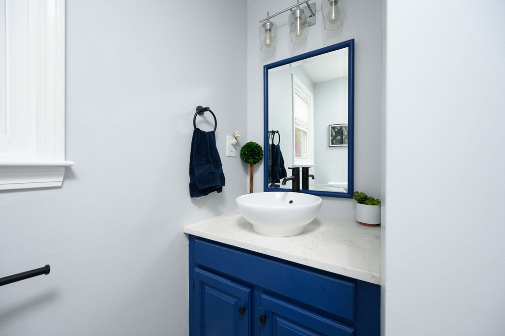 67 School Street Hanover, MA 02339 - Photo 17 of 29 a bathroom with a sink and a mirror