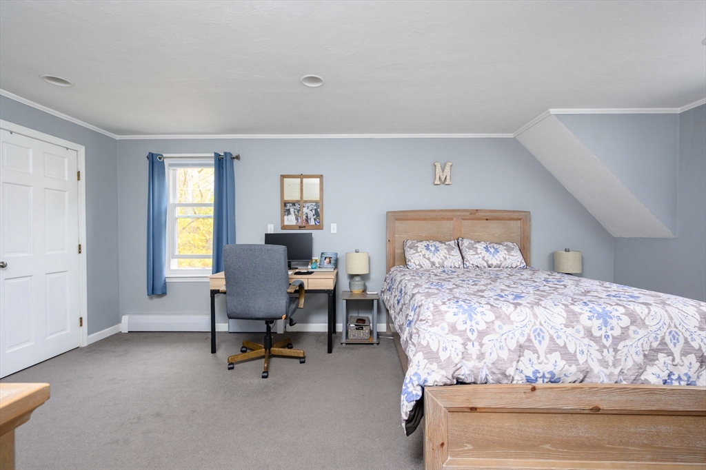 67 School Street Hanover, MA 02339 - Photo 18 of 29 a bedroom with a bed a chair and next to a window