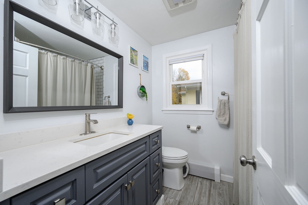 67 School Street Hanover, MA 02339 - Photo 20 of 29 a bathroom with a toilet sink and mirror