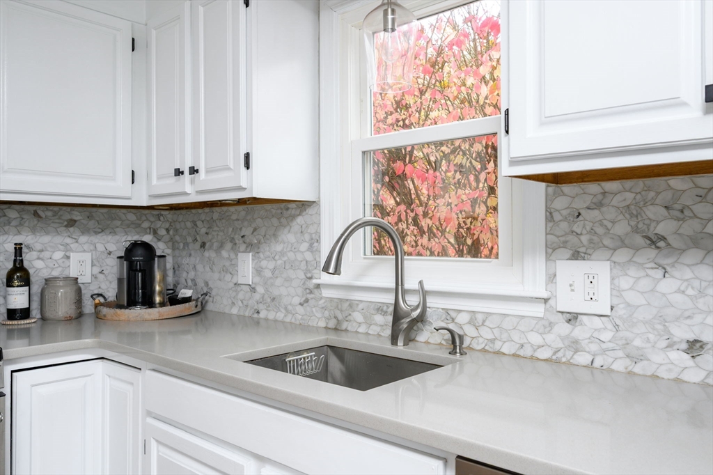 67 School Street Hanover, MA 02339 - Photo 6 of 29 a kitchen with granite countertop a sink and a window