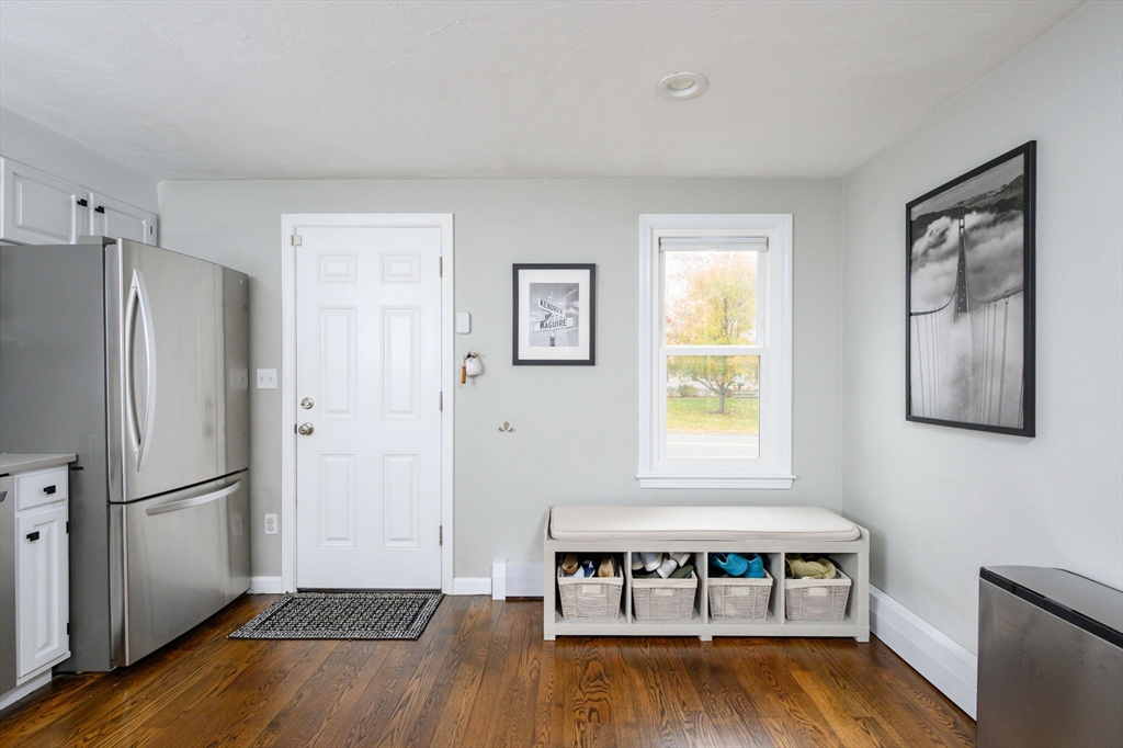 67 School Street Hanover, MA 02339 - Photo 7 of 29 a view of a livingroom with wooden floor and a refrigerator