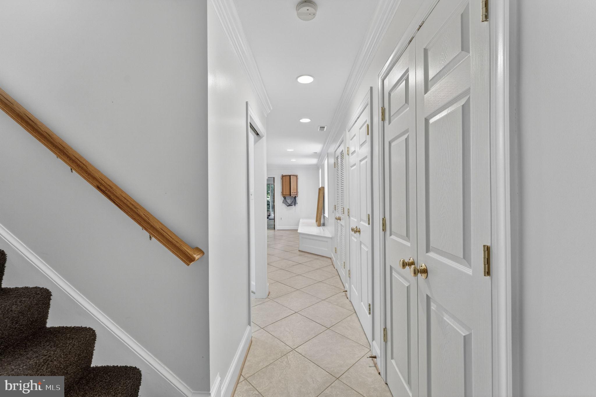 4531 Den Haag Road Warrenton, VA 20187 - Photo 61 of 103 a view of a hallway with wooden floor and staircase