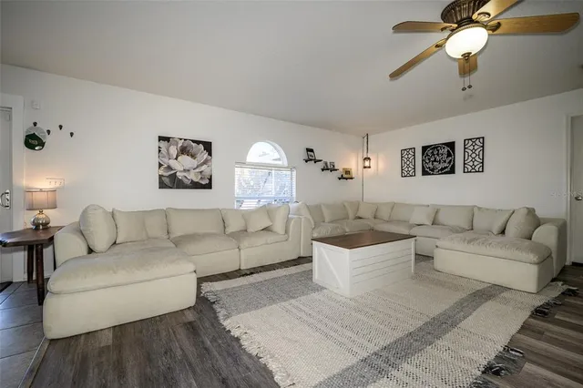 a living room with a table and a rug