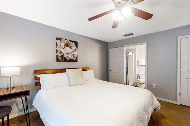 a bathroom with a tub sink and view living room