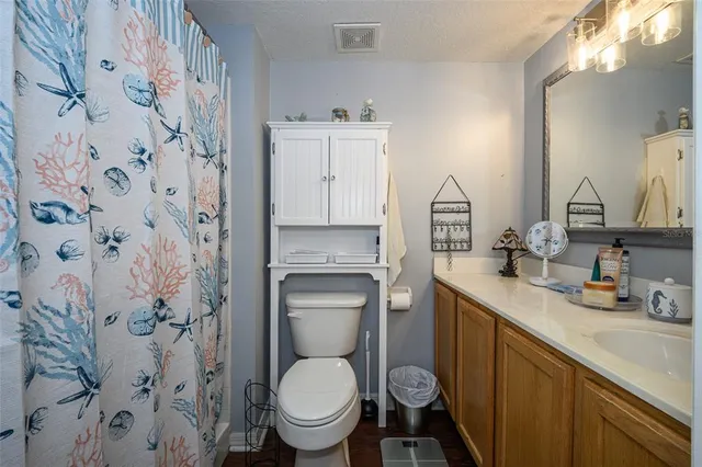 a view of a room with wooden floor and bathroom