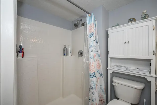 a bedroom with bed and a chandelier