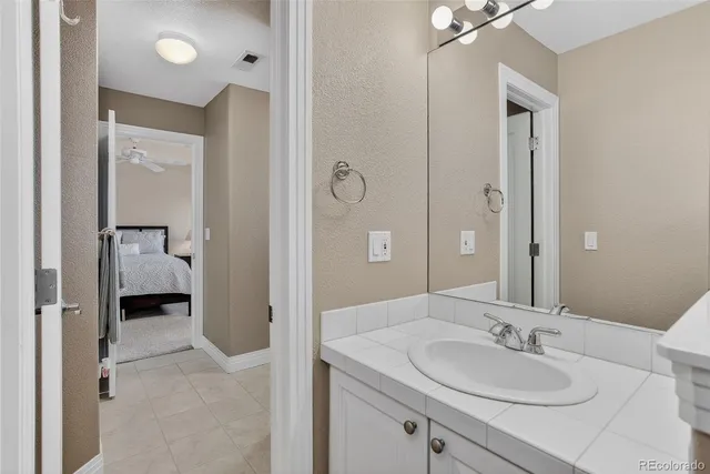 a en suite bathroom with a sink and mirror