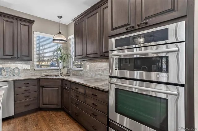 a kitchen with granite countertop cabinets stainless steel appliances and sink