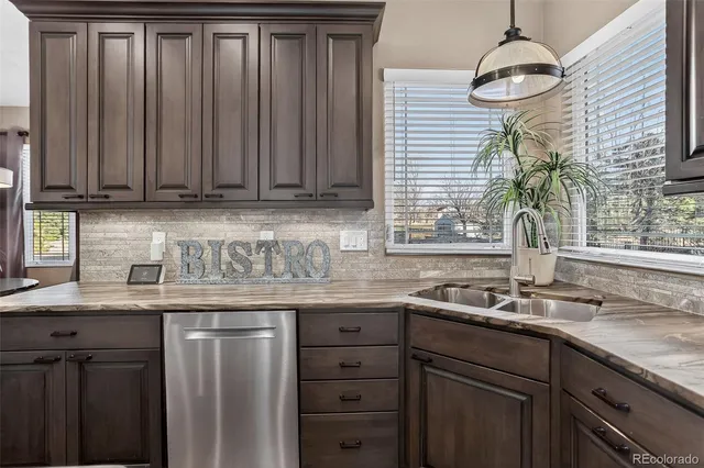a kitchen with granite countertop a sink and a window