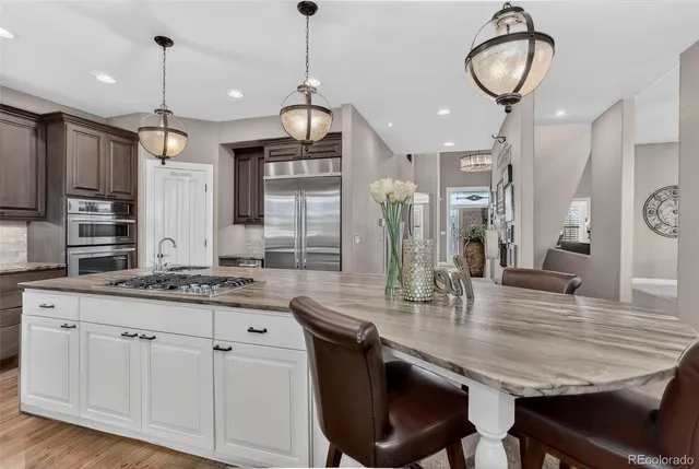a kitchen with kitchen island granite countertop a sink a center island and cabinets