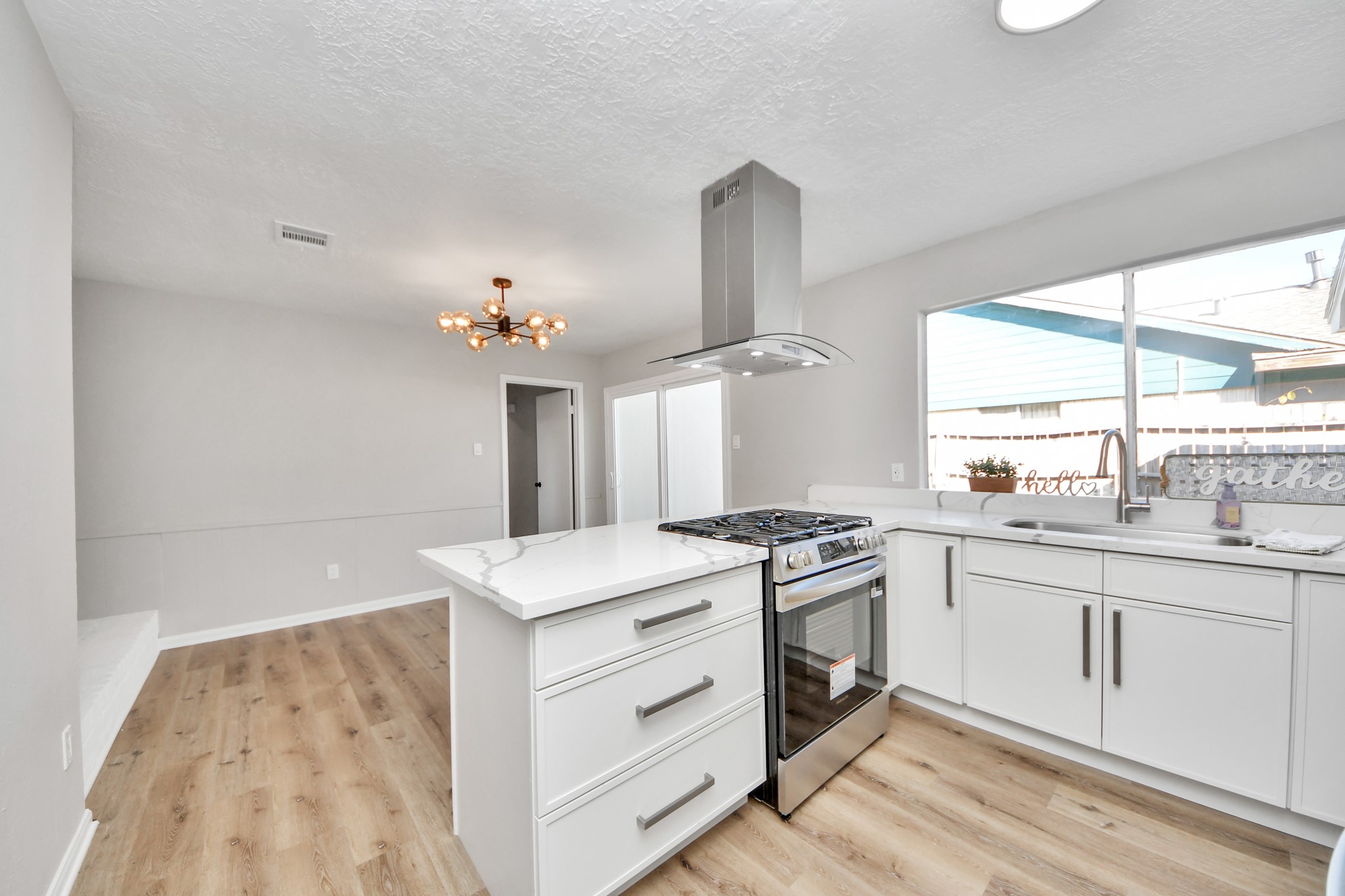 9114 Spellman Road Houston, TX 77031 - Photo 11 of 30 a kitchen with a stove a sink and a window