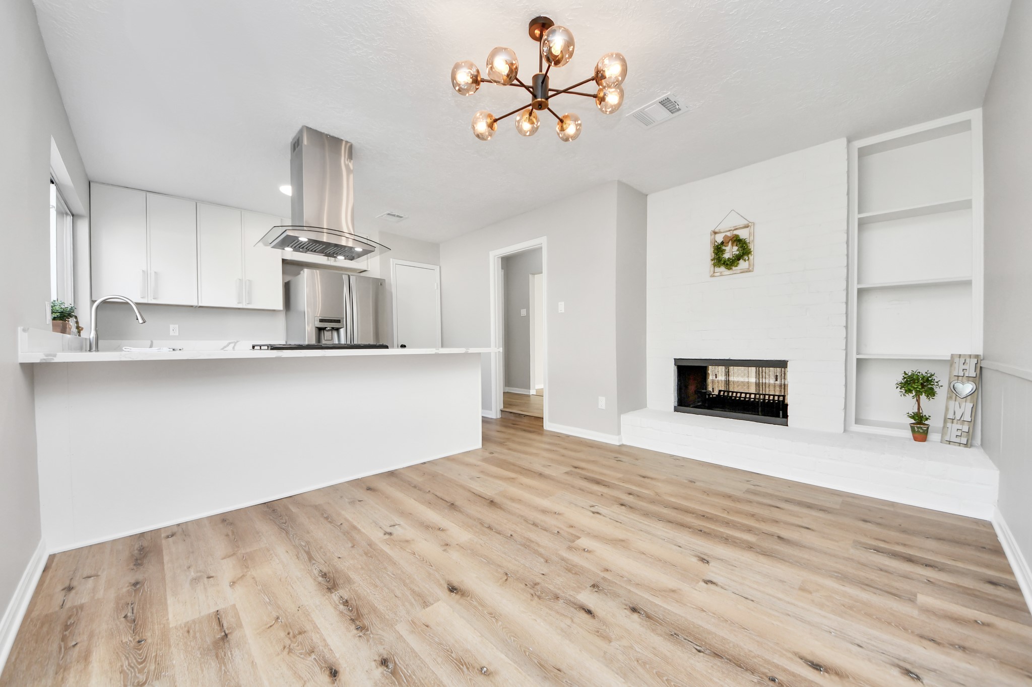 9114 Spellman Road Houston, TX 77031 - Photo 13 of 30 a view of empty room with kitchen and fireplace