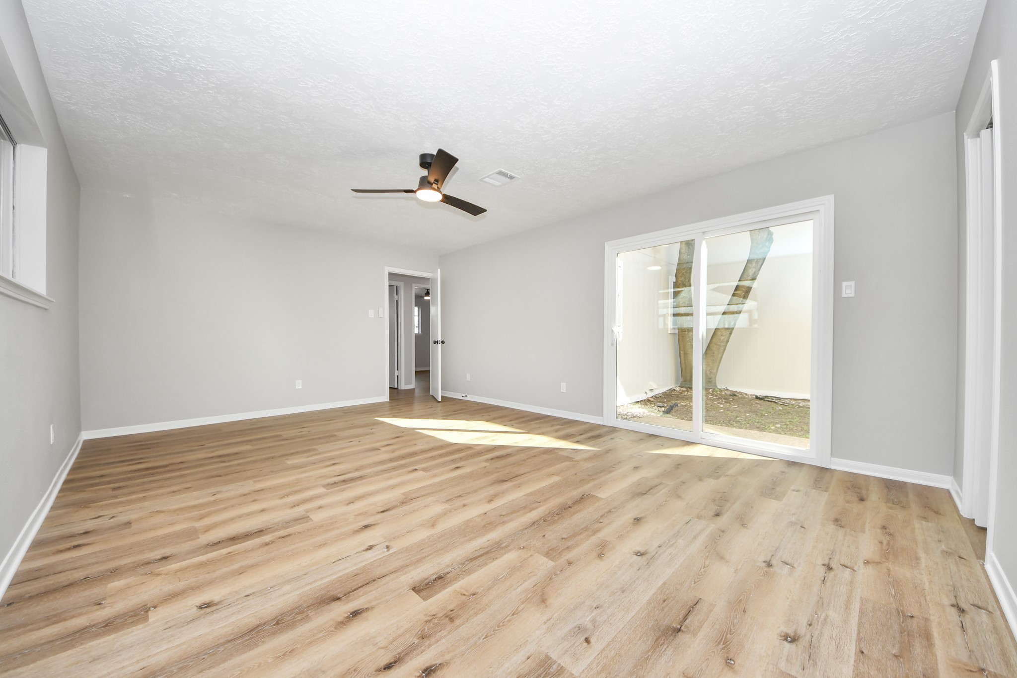9114 Spellman Road Houston, TX 77031 - Photo 16 of 30 a view of an empty room with wooden floor and a window