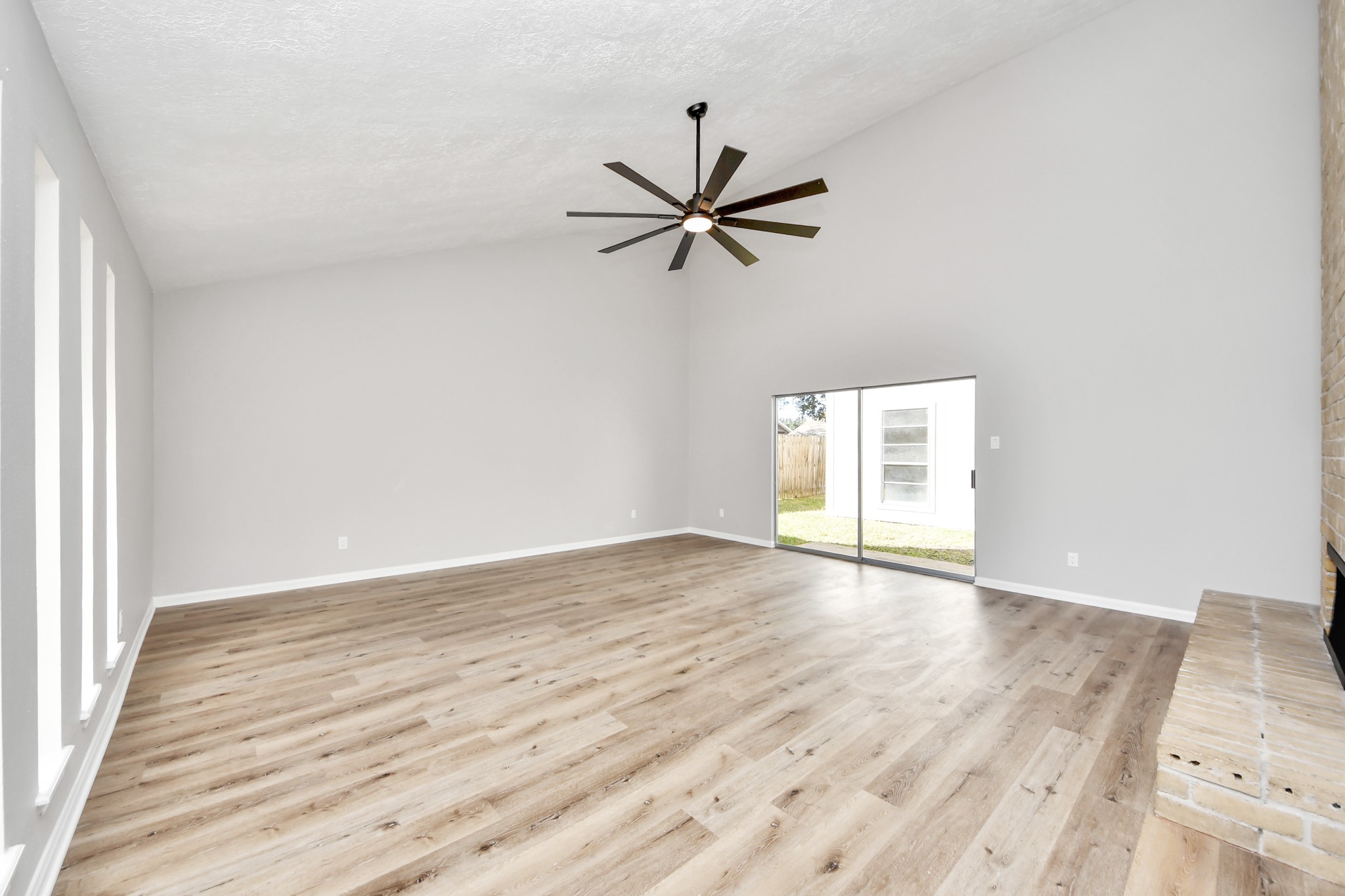 9114 Spellman Road Houston, TX 77031 - Photo 5 of 30 an empty room with wooden floor fan and windows