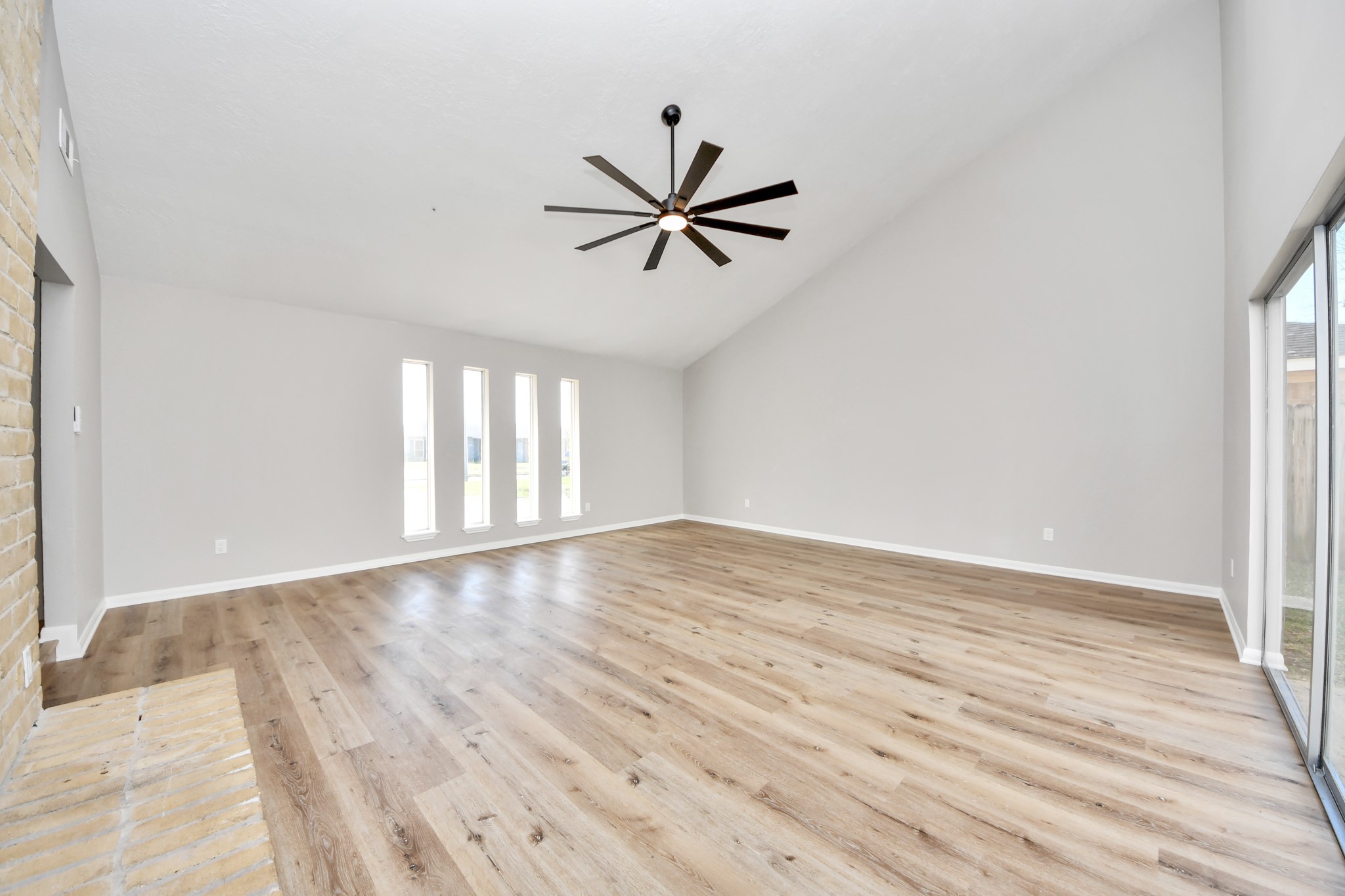9114 Spellman Road Houston, TX 77031 - Photo 7 of 30 an empty room with wooden floor fan and windows