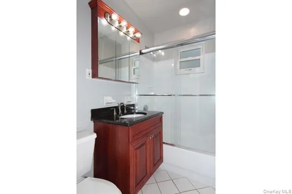 a kitchen with stainless steel appliances granite countertop a sink and a refrigerator