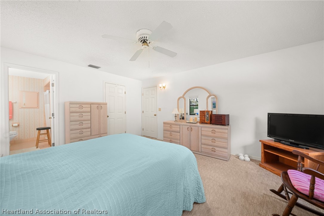 5802 Golden Road Sebring, FL 33875 - Photo 16 of 37 a bedroom with a bed and a flat screen tv