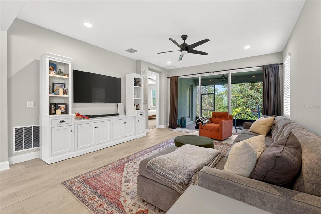 2139 Bay Line Road Oakland, FL 34787 - Photo 12 of 57 a living room with furniture and a flat screen tv