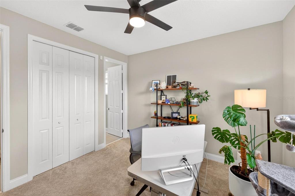 2139 Bay Line Road Oakland, FL 34787 - Photo 19 of 57 a workspace with furniture and potted plant