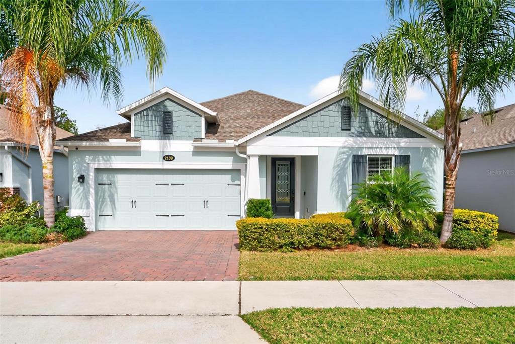 2139 Bay Line Road Oakland, FL 34787 - Photo 2 of 57 a front view of a house with a garden