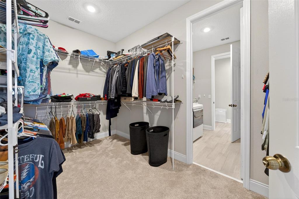 2139 Bay Line Road Oakland, FL 34787 - Photo 26 of 57 a view of walk in closet with clothes and shoes