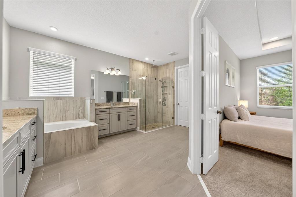 2139 Bay Line Road Oakland, FL 34787 - Photo 27 of 57 a bathroom with a double vanity sink tub and shower