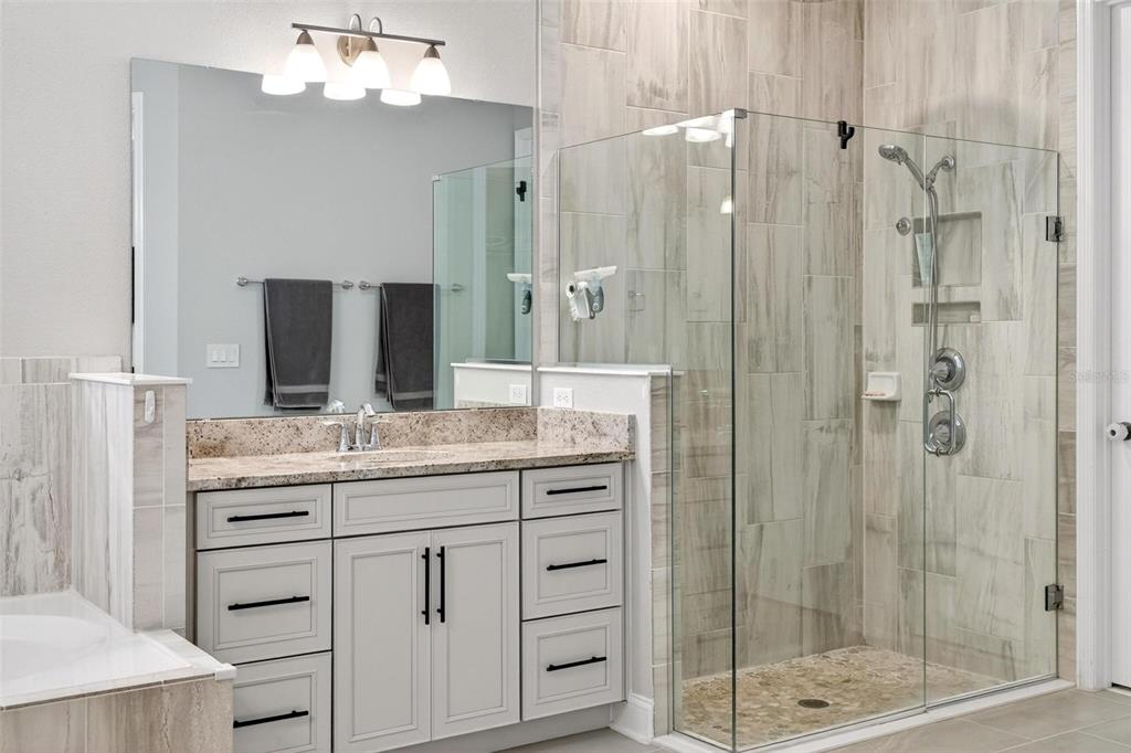2139 Bay Line Road Oakland, FL 34787 - Photo 28 of 57 a bathroom with a granite countertop sink a mirror and shower