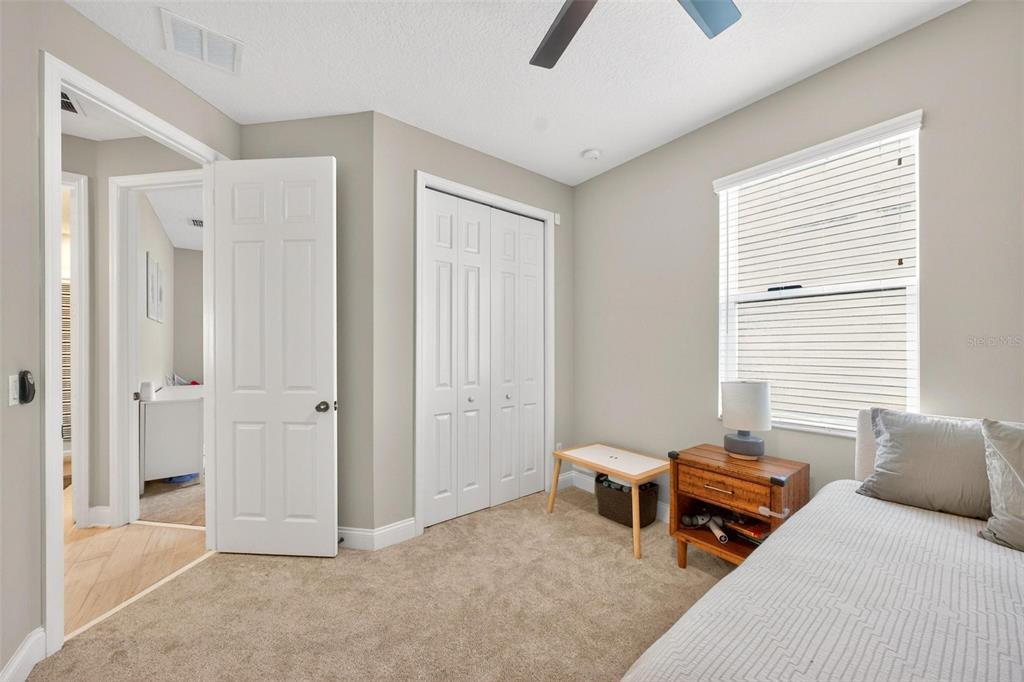 2139 Bay Line Road Oakland, FL 34787 - Photo 34 of 57 a bedroom with a bed and a chandelier