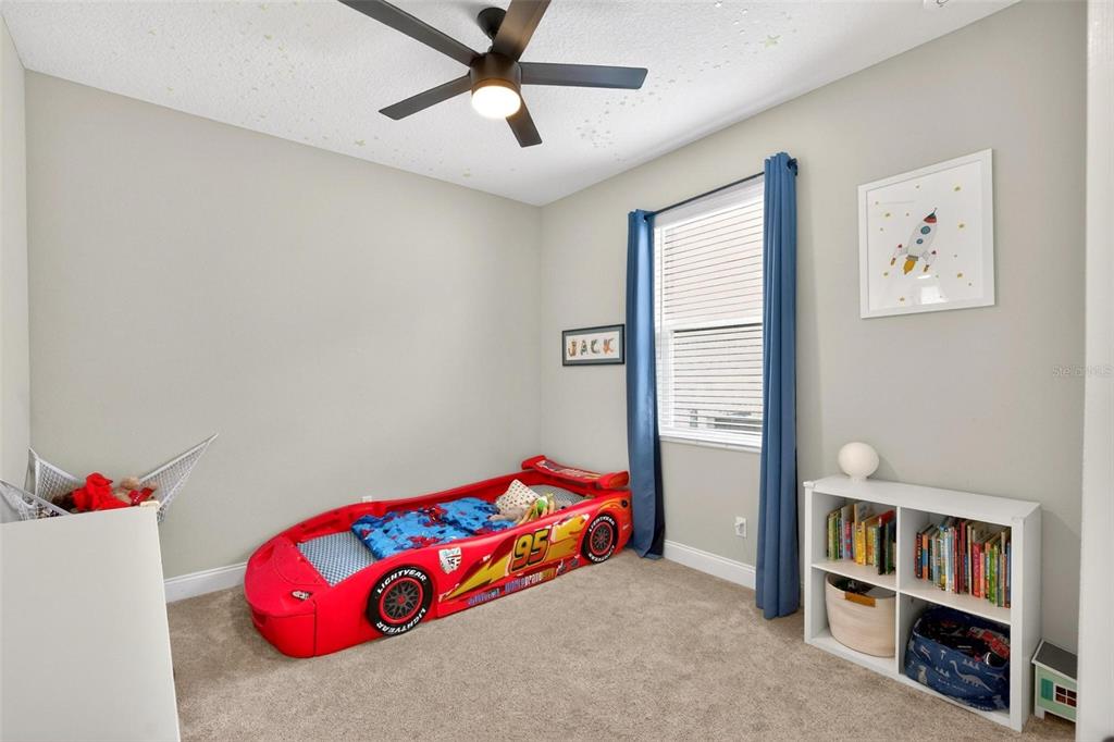 2139 Bay Line Road Oakland, FL 34787 - Photo 35 of 57 a bedroom with a bed and a chandelier