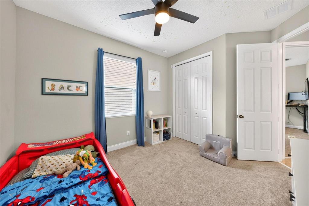 2139 Bay Line Road Oakland, FL 34787 - Photo 36 of 57 a bedroom with a bed and a chandelier