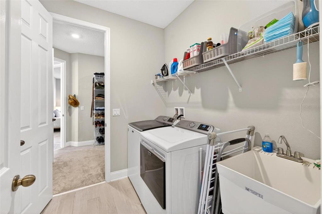 2139 Bay Line Road Oakland, FL 34787 - Photo 40 of 57 a utility room with a sink dryer and washer