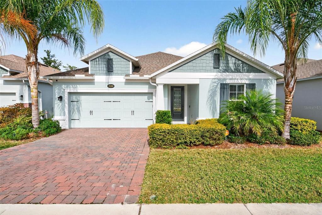 2139 Bay Line Road Oakland, FL 34787 - Photo 56 of 57 a front view of a house with a garden