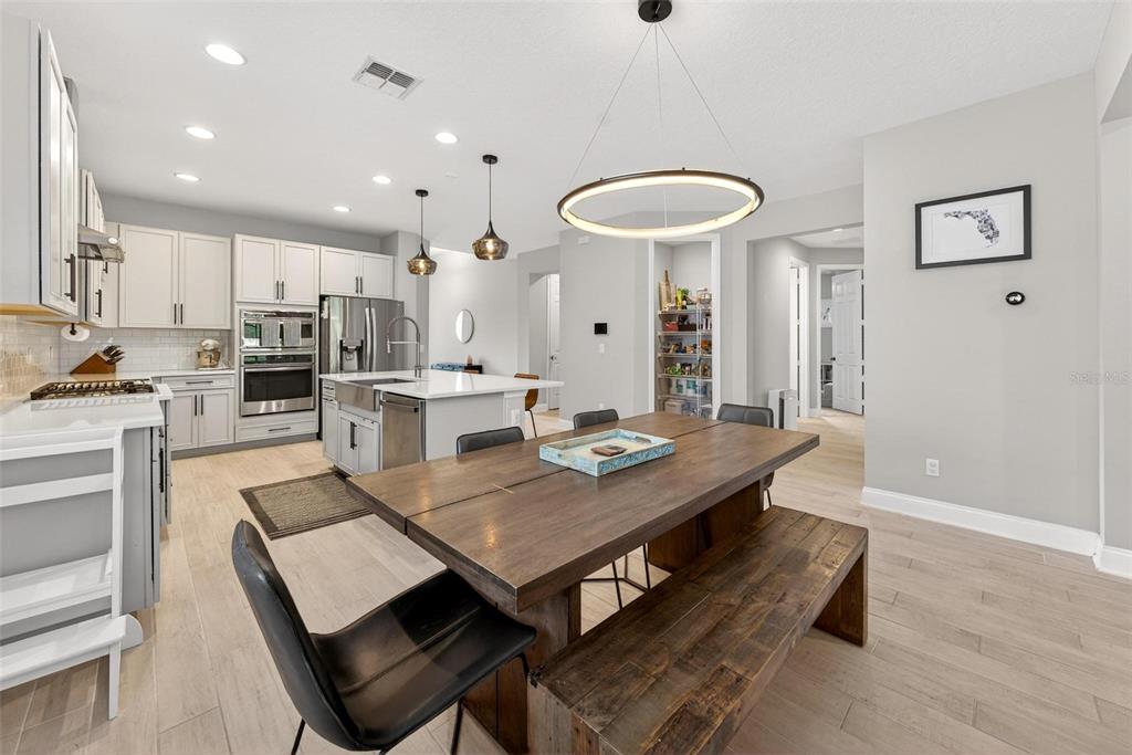 2139 Bay Line Road Oakland, FL 34787 - Photo 9 of 57 a room with stainless steel appliances kitchen island a table and chairs in it