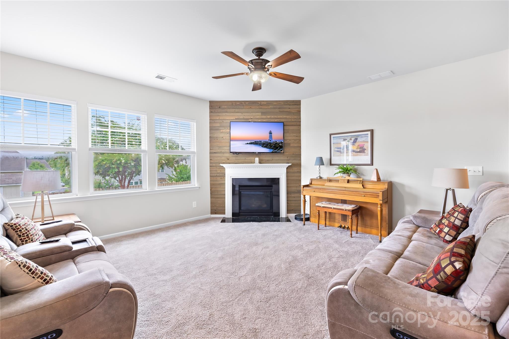 1858 Caprington Drive Fort Mill, SC 29707 - Photo 11 of 46 a living room with furniture a fireplace and a large window