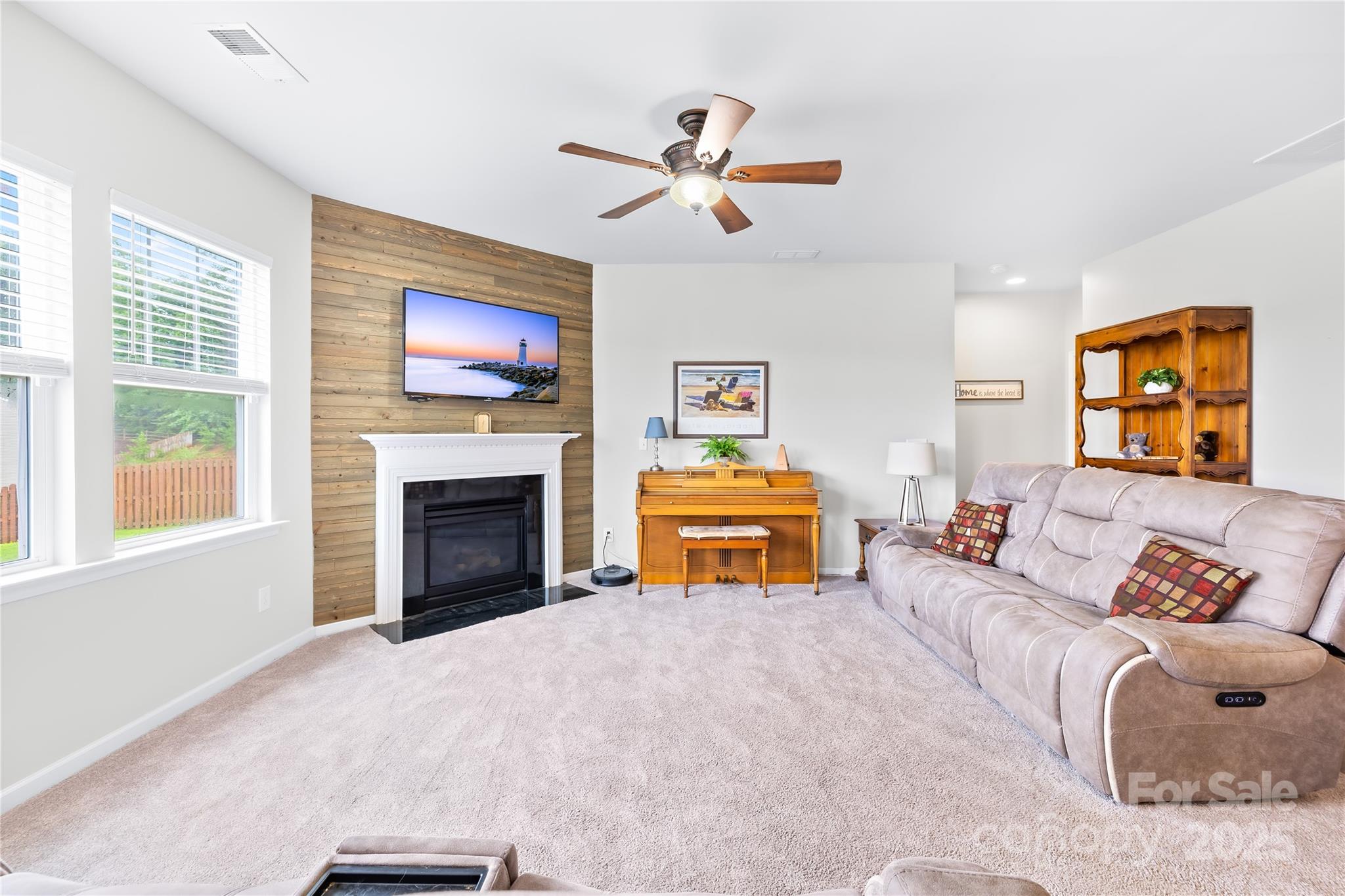 1858 Caprington Drive Fort Mill, SC 29707 - Photo 12 of 46 a living room with furniture a fireplace and a flat screen tv