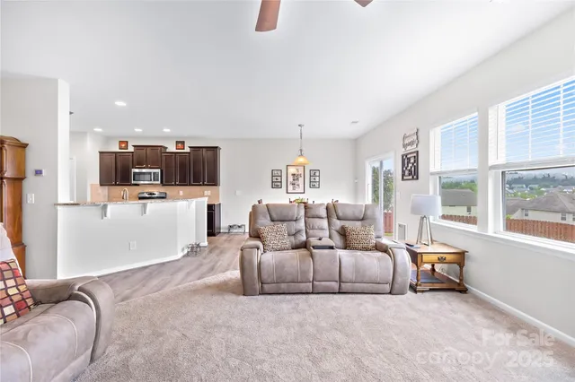 a bedroom with furniture and a large window
