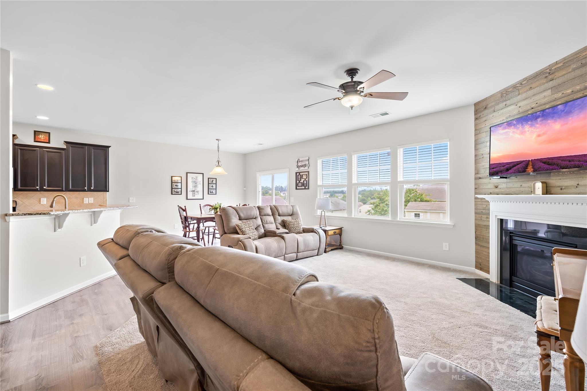 1858 Caprington Drive Fort Mill, SC 29707 - Photo 15 of 46 a living room with furniture a fireplace and a flat screen tv