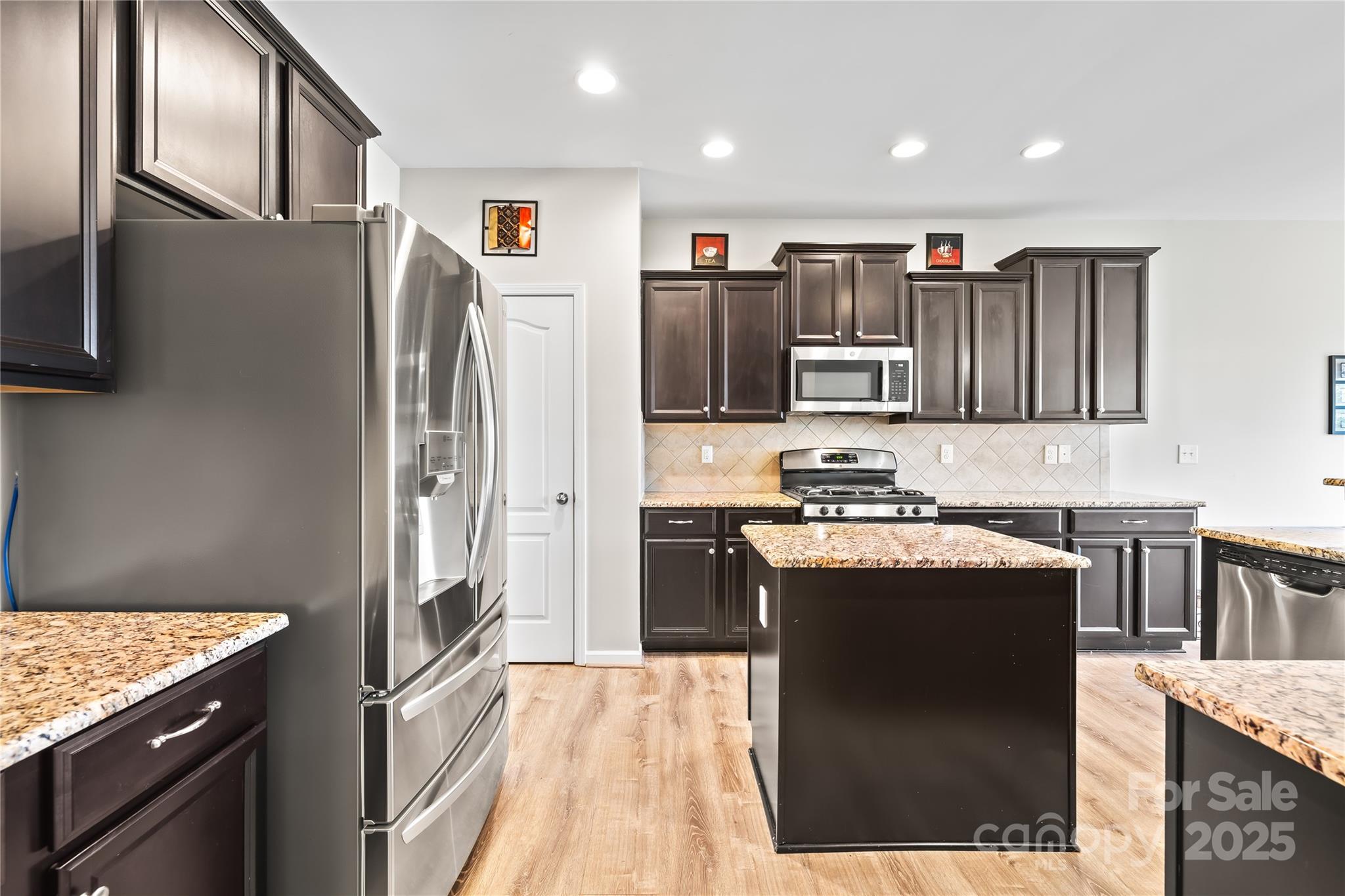 1858 Caprington Drive Fort Mill, SC 29707 - Photo 16 of 46 a kitchen with stainless steel appliances granite countertop a refrigerator stove microwave and sink