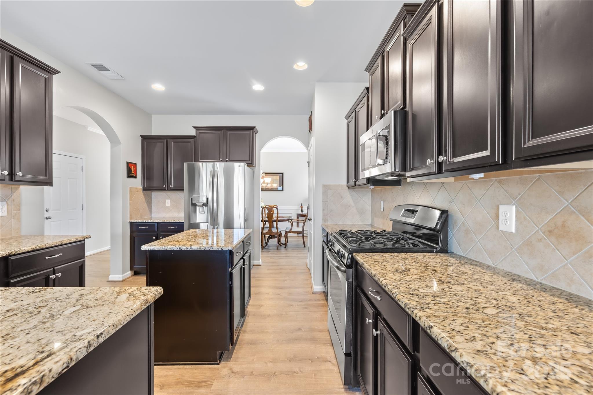 1858 Caprington Drive Fort Mill, SC 29707 - Photo 18 of 46 a kitchen with stainless steel appliances granite countertop a stove refrigerator and cabinets