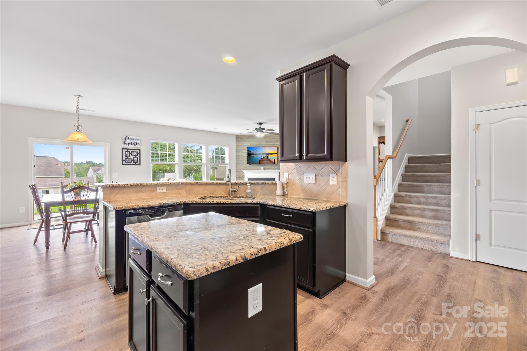 1858 Caprington Drive Fort Mill, SC 29707 - Photo 19 of 46 a kitchen with granite countertop a table chairs stove and refrigerator