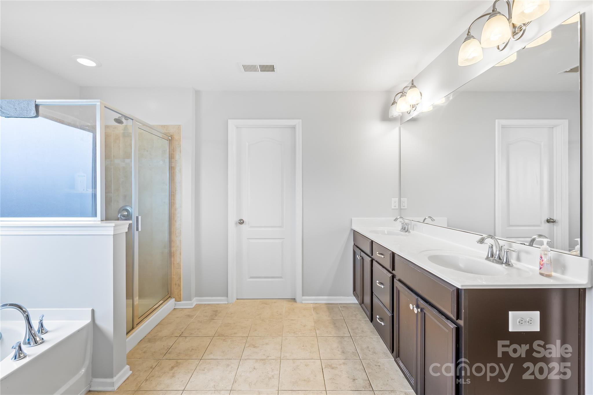 1858 Caprington Drive Fort Mill, SC 29707 - Photo 28 of 46 a bathroom with a double vanity sink a mirror and a shower