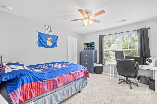 a bedroom with a bed and a desk