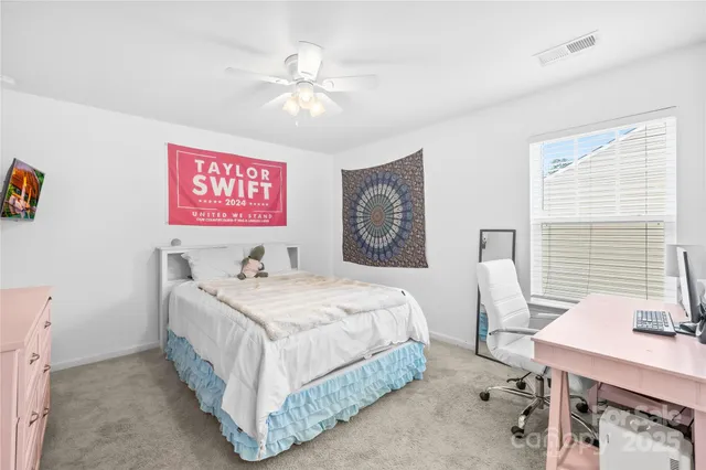 a bedroom that has a bed and a table in it